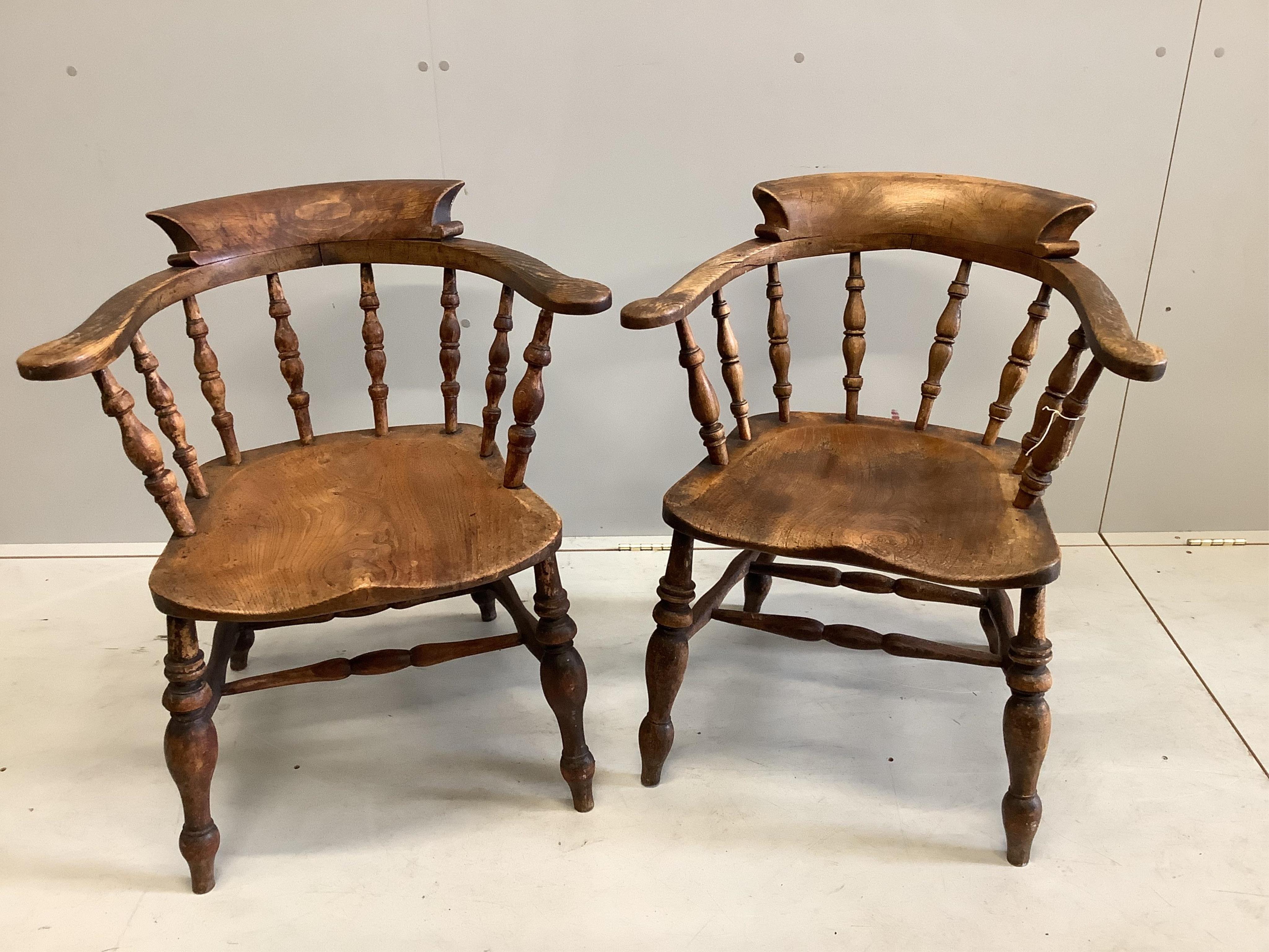 A near pair of Victorian elm and beech Windsor smoker's bow chairs, width 63cm, depth 45cm, height 77cm. Condition - fair